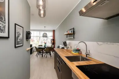 a kitchen with a sink and a counter top at Amsterdam Beach Apartment 52 in Zandvoort