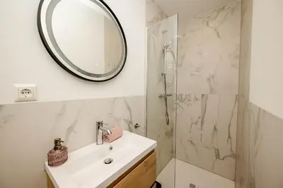 a bathroom with a sink and a mirror at Amsterdam Beach Apartment 52 in Zandvoort