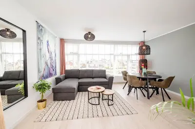a living room with a couch and a table at Amsterdam Beach Apartment 52 in Zandvoort