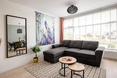 a living room with a couch and a table at Amsterdam Beach Apartment 52 in Zandvoort
