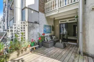 a patio of a building with a couch and some plants at Resident Moose in Amsterdam