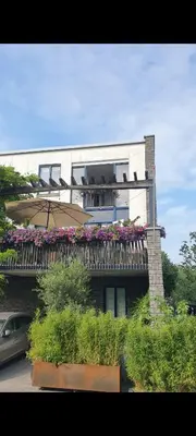 a building with a balcony with flowers on it at Lovely 1 bedroom apartment with garden no smoking in Amsterdam