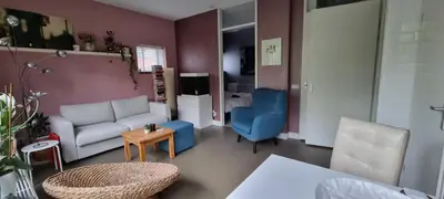 a living room with a white couch and blue chairs at Lovely 1 bedroom apartment with garden no smoking in Amsterdam