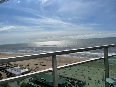 a view of the beach from a balcony at Top View in Zandvoort
