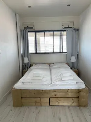 a large bed in a room with a window at Top View in Zandvoort