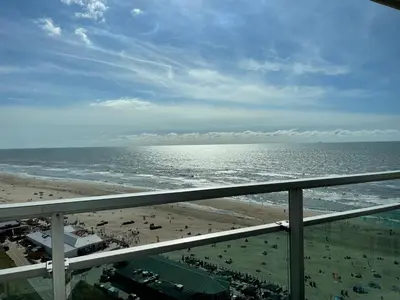a view of the beach and the ocean from a balcony at Top View in Zandvoort