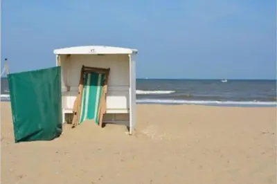 a small shack on a beach in the sand at Piet's Beachhouse in Katwijk aan Zee