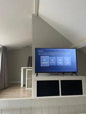 a flat screen tv sitting on top of a white entertainment center at Piet's Beachhouse in Katwijk aan Zee