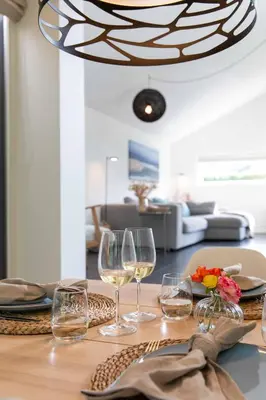 a table with glasses of wine on a table at 8atsea Deluxe Dune Villa Schoorl in Schoorl
