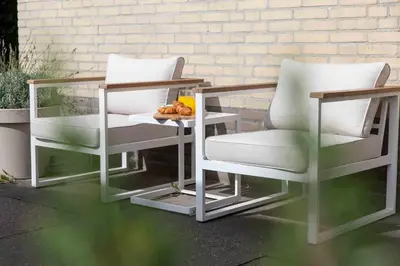 two chairs and a table on a patio at 8atsea Deluxe Dune Villa Schoorl in Schoorl