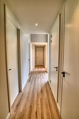 an empty hallway of an apartment with wooden floors at Najade Resort Het Gooi in Eemnes