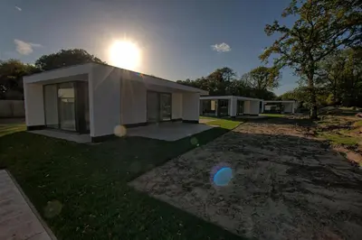a house with a ball in the yard at Najade Resort Het Gooi in Eemnes