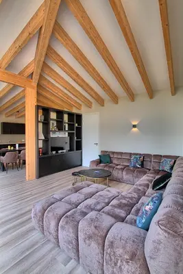 a living room with a large couch and a table at Najade Resort Het Gooi in Eemnes