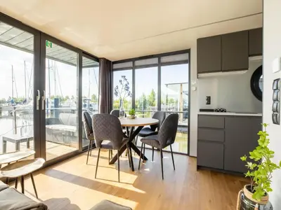 a kitchen and dining room with a table and chairs at Houseboat in Volendam Marina in Volendam