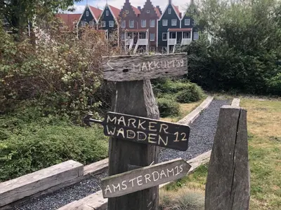 a wooden sign for a market garden with street signs at Houseboat in Volendam Marina in Volendam