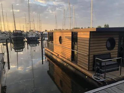 a small boat is docked in a marina at Houseboat in Volendam Marina in Volendam