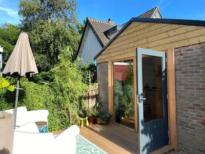 an extension to a garden room with a sliding glass door at Arthouse Lola in Bergen