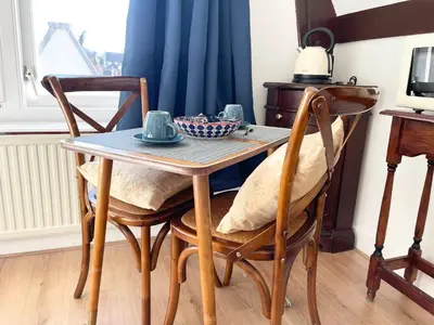 a dining room table with chairs and a table with a bowl on it at Flinder Amsterdam in Amsterdam