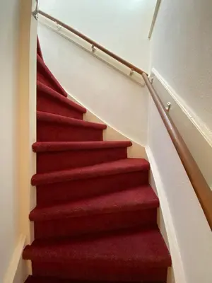 a red carpeted staircase in a house at Flinder Amsterdam in Amsterdam
