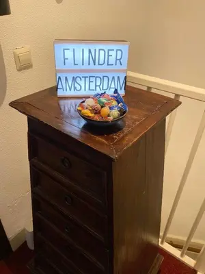 a bowl of fruit on top of a wooden table at Flinder Amsterdam in Amsterdam