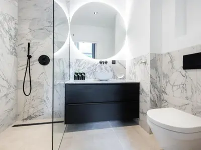 a bathroom with a toilet and a sink and a mirror at STAYSOME Amsterdam Hemonystraat in Amsterdam