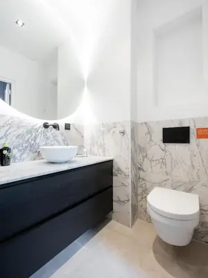 a bathroom with a white toilet and a sink at STAYSOME Amsterdam Hemonystraat in Amsterdam