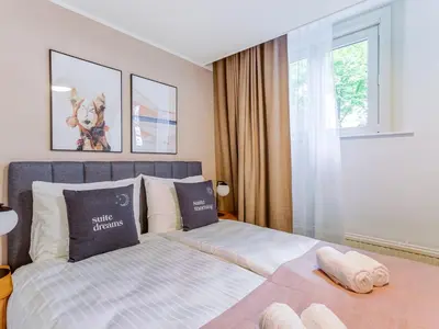 a bedroom with a bed and a window at STAYSOME Amsterdam Hemonystraat in Amsterdam