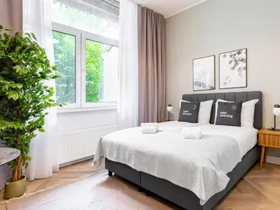 a bedroom with a large bed and a large window at STAYSOME Amsterdam Hemonystraat in Amsterdam