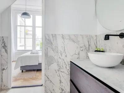 a bathroom with a white sink and a mirror at STAYSOME Amsterdam Hemonystraat in Amsterdam