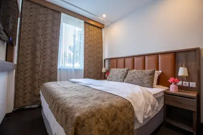 a hotel room with a large bed and a window at Hotel Cataleya in Almere