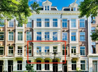 a large white building with red lines on it at New stylish 1 bedroom apt w/ 2 balconies in Centrum in Amsterdam