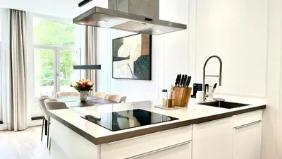 a white kitchen with a sink and a counter at New stylish 1 bedroom apt w/ 2 balconies in Centrum in Amsterdam