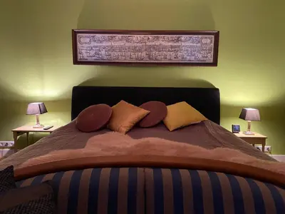 a bedroom with a large bed with pillows on it at King Suite Centre Alkmaar in Alkmaar