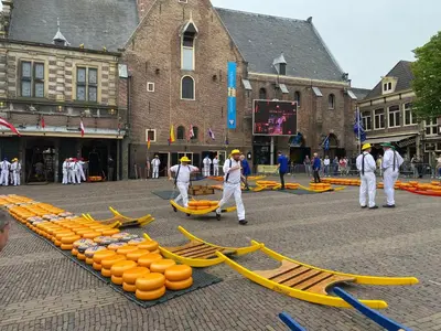 a group of people walking around a street with yellow hoses at King Suite Centre Alkmaar in Alkmaar