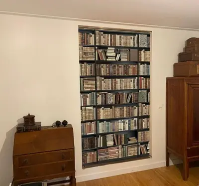 a room with a book shelf filled with books at King Suite Centre Alkmaar in Alkmaar