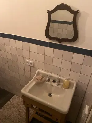 a bathroom with a sink and a mirror on the wall at Queen Suite Centre Alkmaar in Alkmaar