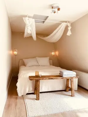 a bedroom with a bed and a wooden table at Casita aan Zee 2 slaapkamers 2 badkamers 3 min van zee in Zandvoort