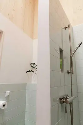 a bathroom with a shower with a glass door at Noorderbed in Amsterdam