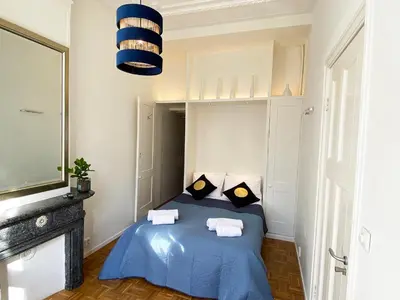 a bedroom with a blue bed with two pillows at Canal Hideaway in Amsterdam