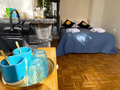 a bedroom with a bed with blue glasses on a table at Canal Hideaway in Amsterdam