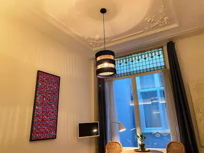 a room with a chandelier and a window at Canal Hideaway in Amsterdam
