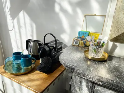 a counter with mugs and cups on a table at Canal Hideaway in Amsterdam