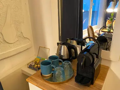 a counter top with cups and tea pots on it at Canal Hideaway in Amsterdam