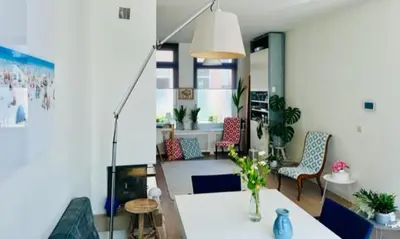 a living room with a white table and chairs at Family Beach House Zandvoort City Center in Zandvoort