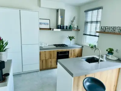 a kitchen with a sink and a counter top at Family Beach House Zandvoort City Center in Zandvoort