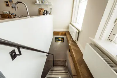 a staircase in a room with a window at B&B Amsterdam Amstel Apartment in Amsterdam