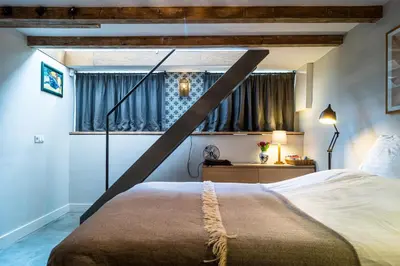 a bedroom with a large bed and a window at B&B Amsterdam Amstel Apartment in Amsterdam