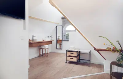 a living room with a sink and a staircase at Boutique Hotel Bellevue in Blaricum