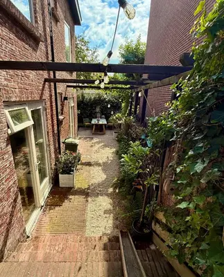 a brick alley with a table in a building at Appartement van der Zee in Zandvoort
