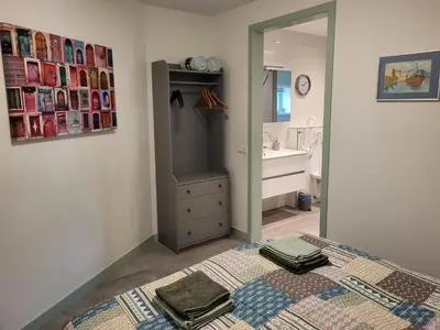 a bathroom with a bed and a sink and a mirror at B & B De Tocht in Berkhout